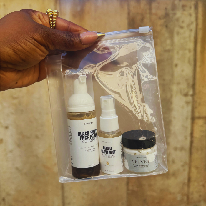 Hand holding a clear bag with travel sized skincare products 