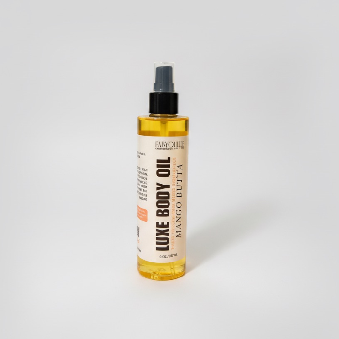 Bottle of Luxe Body Oil with Mango Butter on a white background